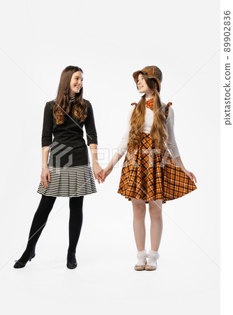 Studio shot of young beautiful happy girl, teenager in retro style outfit, fashion of 70s, 80s years isolated on white background. Concept of art, friendship, hope, youth Studio shot of young beautiful happy girl, teenager in retro style outfit, fashion of 70s, 80s years isolated on white background. Concept of art, friendship, hope, youth 89902836