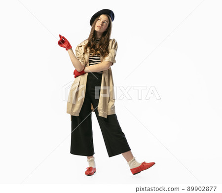 Portrait of young dreaming girl, teen in retro style clothes posing at white studio background. Concept of art, beuty, youth, vintage and human emotions. 89902877