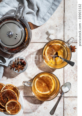 Two cups of hot black tea with lemon on pink tile background. Breakfast concept. Top view Two cups of hot black tea with lemon on pink tile background. Breakfast concept. Top view 89903182