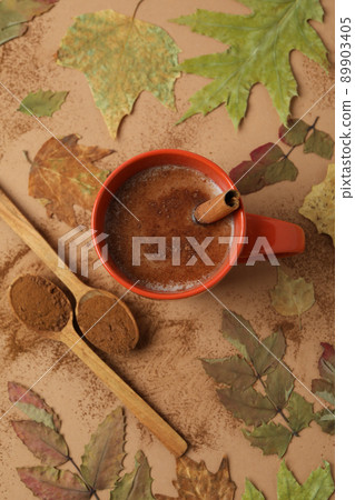 Concept of tasty drink with cocoa on beige background Concept of tasty drink with cocoa on beige background 89903405