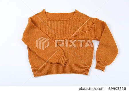Orange sweater on white background, top view 89903516