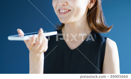A woman talking on a smartphone A woman talking on a smartphone 89905668