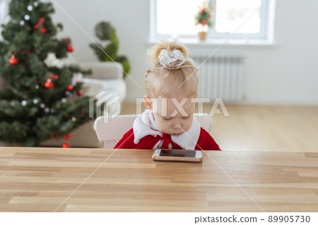 Deaf child girl with cochlear implant on living room with christmas tree copy space and place for advertising - deafness diversity and innovative hearing aid medical technologies Deaf child girl with cochlear implant on living room with christmas tree copy space and place for advertising - deafness diversity and innovative hearing aid medical technologies 89905730