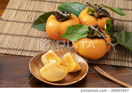 Persimmon with leaves and persimmon cut Persimmon with leaves and persimmon cut 89905947