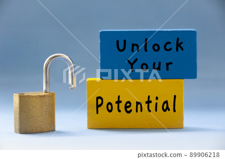 Unlock your potential text on wooden blocks with pad lock on light blue background. Unlock your potential text on wooden blocks with pad lock on light blue background. 89906218