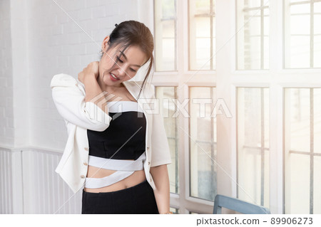 Office syndrome concept. Businesswoman massaging neck, suffering from pain after sedentary working in incorrect posture. Employee massaging stiff neck muscles at workplace. 89906273