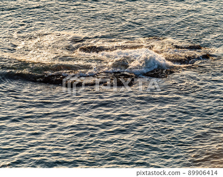 Beautiful early summer evening view of the Sea of Japan, gentle waves approaching the rocks Beautiful early summer evening view of the Sea of Japan, gentle waves approaching the rocks 89906414