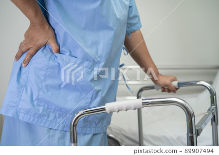 Asian lady woman patient walk with walker at nursing hospital ward, healthy strong medical concept Asian lady woman patient walk with walker at nursing hospital ward, healthy strong medical concept 89907494