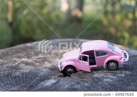 Toy pink car. Car insurance concept with accident car toy lay down Toy pink car. Car insurance concept with accident car toy lay down 89907688
