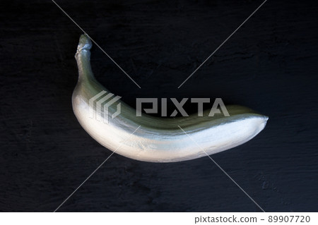 Silver banana on a black background. trend concept Silver banana on a black background. trend concept 89907720
