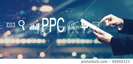 PPC - Pay per click concept with businessman using a tablet PPC - Pay per click concept with businessman using a tablet 89908323