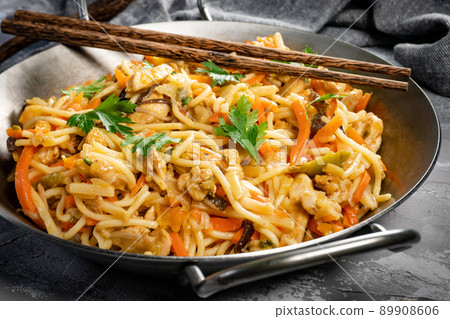 Fried noodles with chicken and vegetables. Fried noodles with chicken and vegetables. 89908606