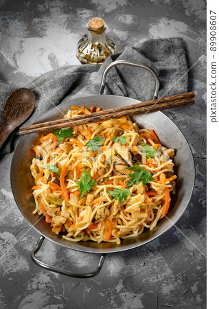 Fried noodles with chicken and vegetables. Fried noodles with chicken and vegetables. 89908607