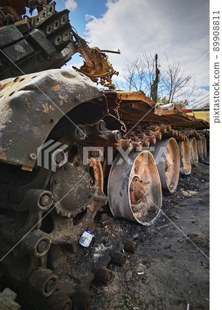 Kyiv region, Ukraine - May 15, 2022: War in Ukraine. Highway Kyiv - Zhytomyr. People take selfies against destroyed russian tank after russian atack in Febrary. 89908811