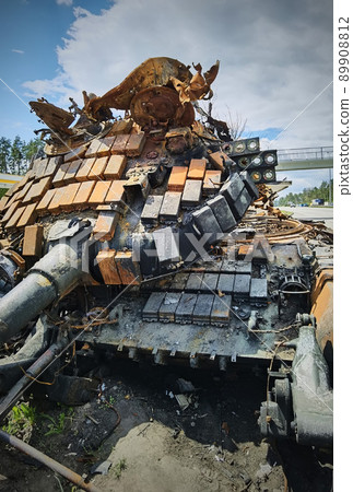 Kyiv region, Ukraine - May 15, 2022: War in Ukraine. Highway Kyiv - Zhytomyr. People take selfies against destroyed russian tank after russian atack in Febrary. 89908812