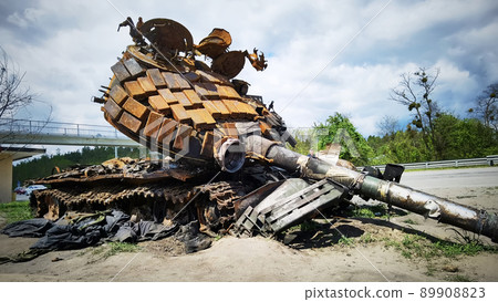 Kyiv region, Ukraine - May 15, 2022: War in Ukraine. Highway Kyiv - Zhytomyr. People take selfies against destroyed russian tank after russian atack in Febrary. Kyiv region, Ukraine - May 15, 2022: War in Ukraine. Highway Kyiv - Zhytomyr. People take selfies against destroyed russian tank after russian atack in Febrary. 89908823