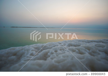 Beautiful sunrise at Dead Sea in Israel with rocks of salt at foreground 89908843