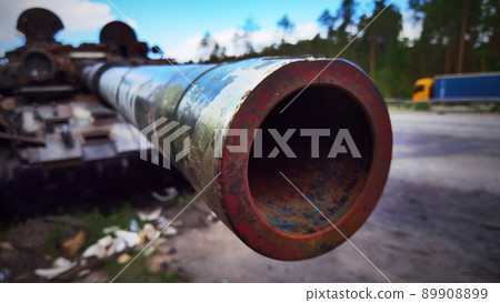 Kyiv region, Ukraine - May 15, 2022: War in Ukraine. Highway Kyiv - Zhytomyr. People take selfies against destroyed russian tank after russian atack in Febrary. 89908899