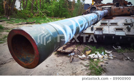 Kyiv region, Ukraine - May 15, 2022: War in Ukraine. Highway Kyiv - Zhytomyr. People take selfies against destroyed russian tank after russian atack in Febrary. Kyiv region, Ukraine - May 15, 2022: War in Ukraine. Highway Kyiv - Zhytomyr. People take selfies against destroyed russian tank after russian atack in Febrary. 89908900