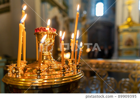 Burning candles in an Orthodox church Burning candles in an Orthodox church 89909395