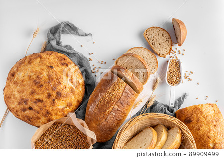 Homemade delicious freshly baked heathy natural bread food group on gray background Homemade delicious freshly baked heathy natural bread food group on gray background 89909499
