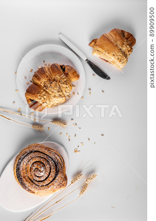 Homemade freshly bakery products with powdered sugar on the top top view and wheat 89909500