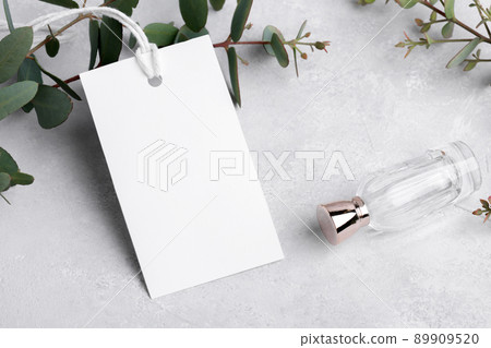 Rectangle white gift tag mockup with eucalyptus leaves on grey background, label tag mockup, Wedding favor tag 89909520