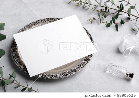Wedding invitation card mockup 7x5 on silver retro vintage plate on grey background with eucalyptus, menu card mockup 89909529