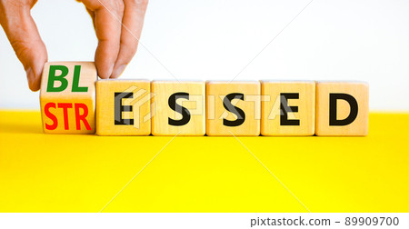 Blessed or stressed symbol. Businessman turns wooden cubes and changes the concept word Stressed to Blessed. Beautiful yellow table white background. Business blessed or stressed concept. Copy space. Blessed or stressed symbol. Businessman turns wooden cubes and changes the concept word Stressed to Blessed. Beautiful yellow table white background. Business blessed or stressed concept. Copy space. 89909700