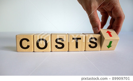 Hand is turning a cube and changes the direction of an arrow symbolizing that the costs is going down or vice versa. Beautiful white background, copy space. Business concept. Hand is turning a cube and changes the direction of an arrow symbolizing that the costs is going down or vice versa. Beautiful white background, copy space. Business concept. 89909701