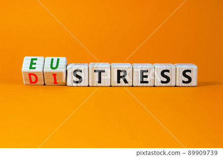 Eustress or distress symbol. Turned wooden cubes and changed the concept word Eustress to Distress. Beautiful orange table orange background, copy space. Psychlogical distress or eustress concept. Eustress or distress symbol. Turned wooden cubes and changed the concept word Eustress to Distress. Beautiful orange table orange background, copy space. Psychlogical distress or eustress concept. 89909739