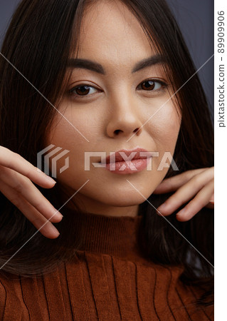 beautiful woman brown sweater glamor posing smile fashion Gray background beautiful woman brown sweater glamor posing smile fashion Gray background 89909906
