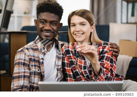 Multiracial family with laptop holding keys from new flat Multiracial family with laptop holding keys from new flat 89910983