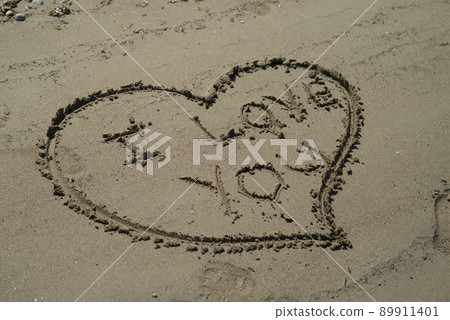 Closeup of heart and I love you text writing on the sand on the beach Closeup of heart and I love you text writing on the sand on the beach 89911401