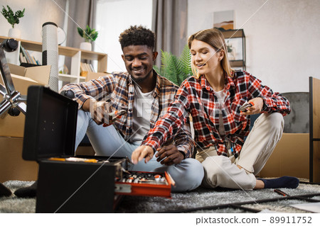 Multi ethnic couple choosing repair tools at new home 89911752