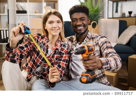 Caucasian woman and african man with instruments at home 89911757