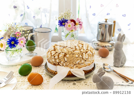 Easter concept with Italian easter cake Colomba, coloured eggs, spring flowers and rabbits Easter concept with Italian easter cake Colomba, coloured eggs, spring flowers and rabbits 89912138