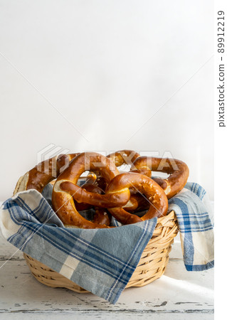 Brezels or pretzels in bread basket with napkin  89912219