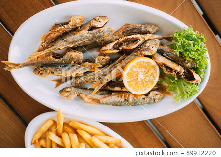 Dish Of Georgian National Cuisine: Mullet Fish With orange and french fries. fish and chips 89912220