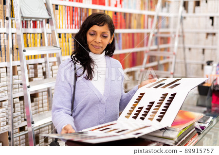 Woman choosing hair color from palette at store 89915757