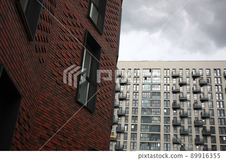 Exterior of a high-rise apartment building facade, windows and balconies. 89916355