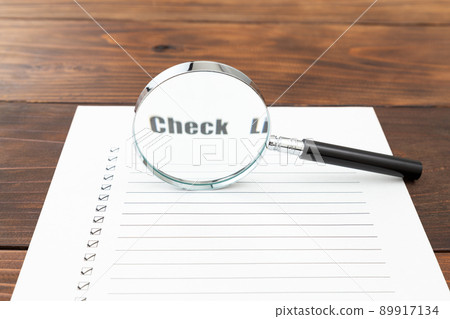 Checklist and magnifying glass 89917134