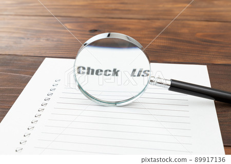 Checklist and magnifying glass 89917136