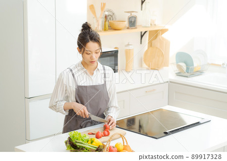 A woman standing in the kitchen A woman standing in the kitchen 89917328