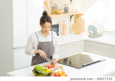 A woman standing in the kitchen A woman standing in the kitchen 89917330