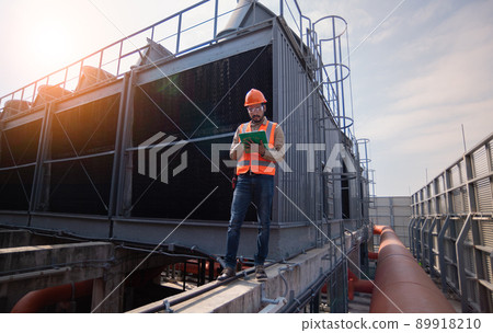 Industry engineer under checking the industry cooling tower air conditioner is water cooling tower air chiller HVAC of large industrial building to control air system. Industry engineer under checking the industry cooling tower air conditioner is water cooling tower air chiller HVAC of large industrial building to control air system. 89918210