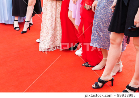 Feet of prom guests, girls stand on a red carpet, 89918993