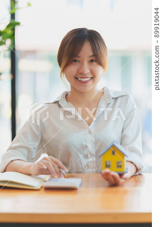 A woman holding and checking house model .Real Estate House Appraisal And Inspection and Insurance concept. 89919044