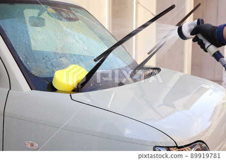 Scenery of car wash while shampooing after flushing small garbage with water Scenery of car wash while shampooing after flushing small garbage with water 89919781