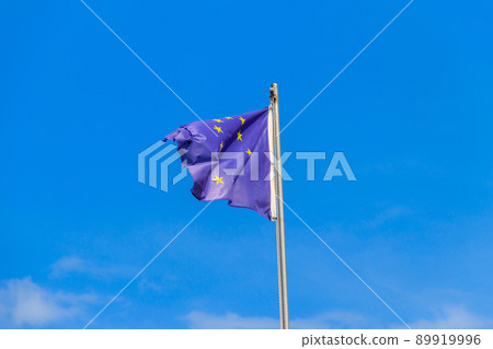 Waving flag of European Union against blue sky Waving flag of European Union against blue sky 89919996